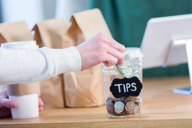 istock Coffee shop customer leaves tip for barista 927889958