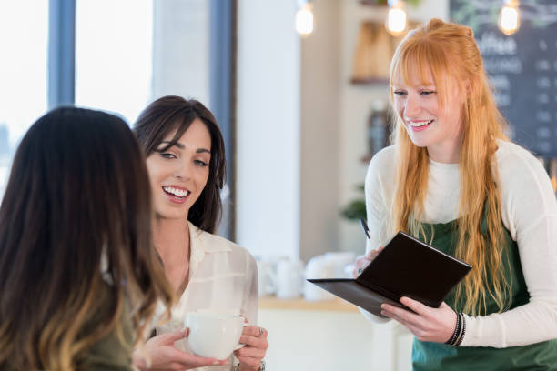 istock Friendly waitress takes a customer's order 927891110