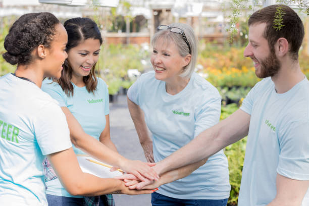 istock Plant nursery volunteers with hands together in unity 927891722