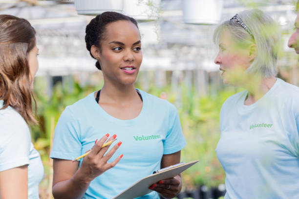 istock Group of people volunteering in plant nursery 927891736