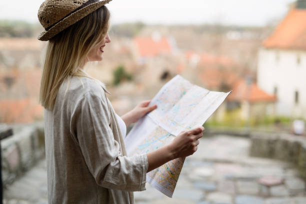 istock Tourist woman looking at map 927893114