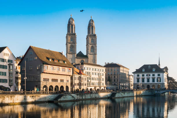 muelle del río limmat e iglesia de grossmunster, zúrich, suiza - grossmunster cathedral fotografías e imágenes de stock