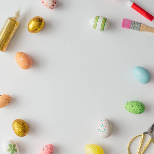 istock Creative Easter layout made of colorful eggs, gold glitter, brush and paint. Flat lay background. 927908300