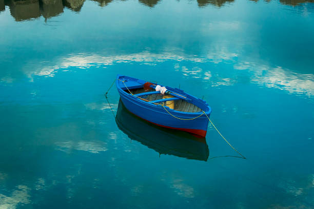 Beautiful picture of a boat with a cloudy reflection