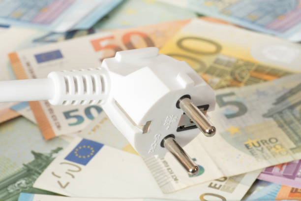 istock An electric plug and many euro banknotes 927916068