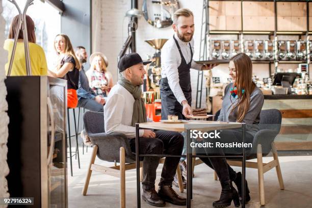 Couple Ordering In The Cafe Stock Photo - Download Image Now - Restaurant, Waiter, Serving Food and Drinks