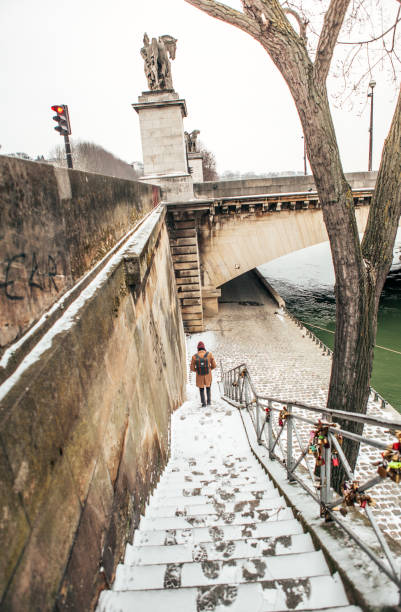 istock Man walking to the Eiffel tower with snow 927916868