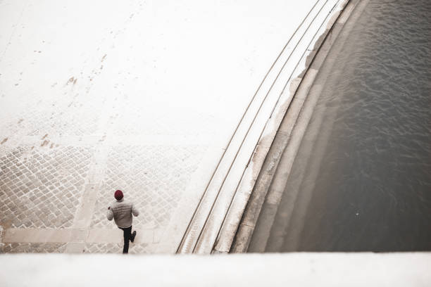 istock Man walking to the Eiffel tower with snow 927919606