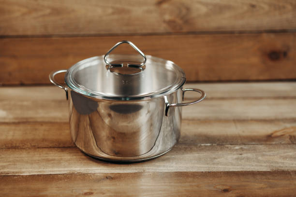 istock Stainless saucepan on wooden table 927923880