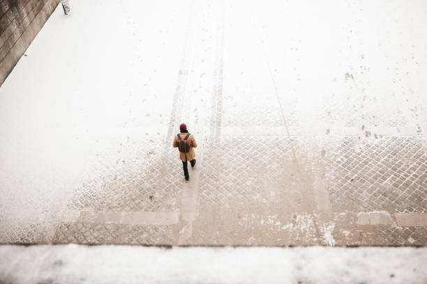 Man walking to the Eiffel tower with snow