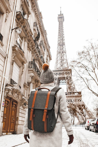 istock Woman walking to the Eiffel tower with snow 927927176