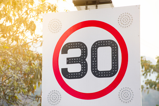 Round Red Road Sign: Speed limit 30 kilometers per hour.