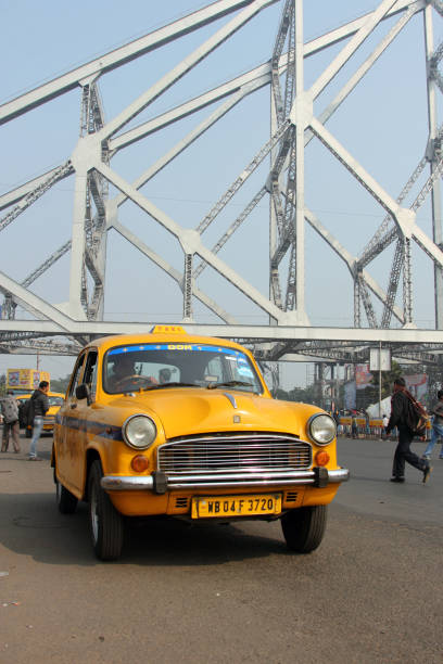 yellow taxis of kolkata city, india - vertical lift bridge imagens e fotografias de stock