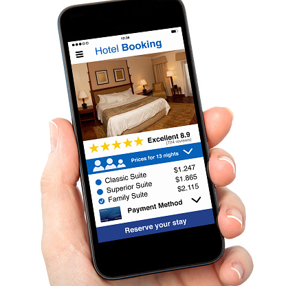 isolated woman hand holding phone with app hotel booking on screen