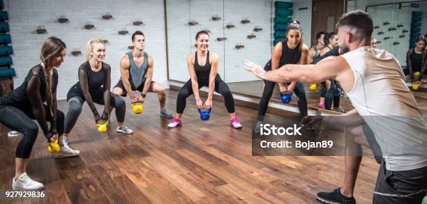 Panoramic View Of Sporty People Training With Weights With Assistance Of Their Coach At Health Club Stock Photo - Download Image Now