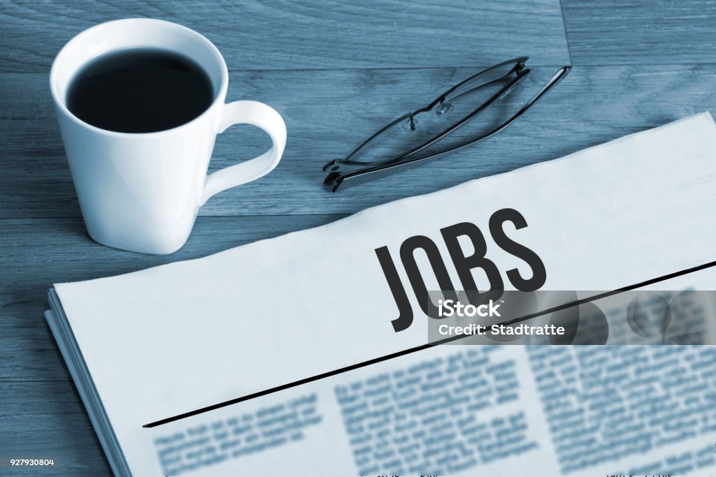 Cup of coffee, reading glasses and a newspaper with job advertisements during a job search Cup of coffee, reading glasses and a newspaper with job advertisements in a job search Job Search Stock Photo