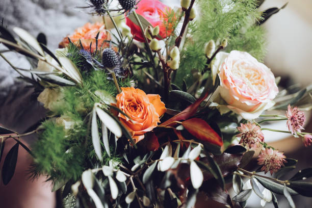 istock Modern florist working with flowers in workshop - with detail on hands 927939620