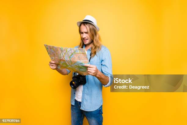 While Sightseening Sad And Disappointed Man Lost His Way To The Hotel And Now He Is Looking At The Map And Trying To Define The Road To The Point Of Destination Stock Photo - Download Image Now