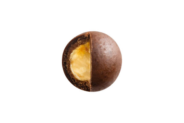 istock Sugared hazelnut dragees in chocolate isolated on white background 927940260