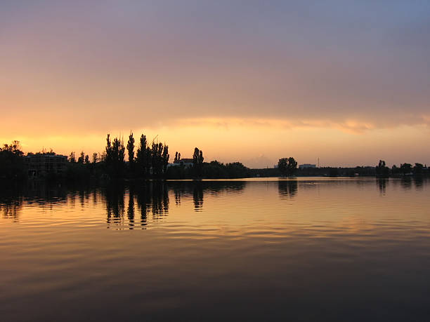 Sunset or morning sunrise near calm lake stock photo