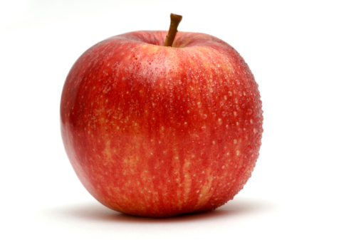 red apple covered in water droplets against white