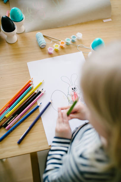 istock Little cute girls draws easter rabbit 927958638