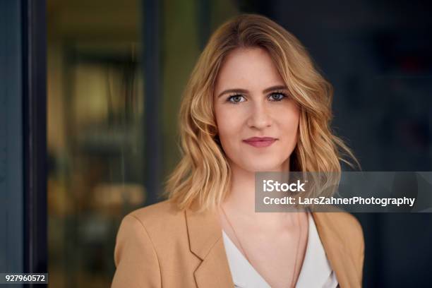 Elegante Frau Stand Vor Einem Dunklen Hintergrund Stockfoto und mehr Bilder von Frauen - Frauen, Ernst, Bewerbungsformular