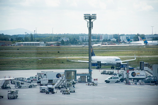 Traffic road and people working checking with airplane takeoff and landing on runway at Frankfurt International Airport on September 10, 2017 in Frankfurt, Germany