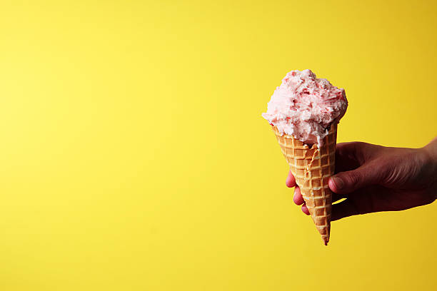 istock Strawberry Ice Cream Cone on Yellow with Space for Copy 92796624