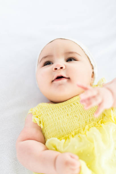 istock Baby Girl Lying On Back, Smiling And Gesturing. 927974926