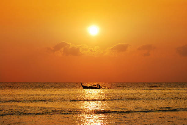 istock fisherman on boat in morning ,Thailand 927975644