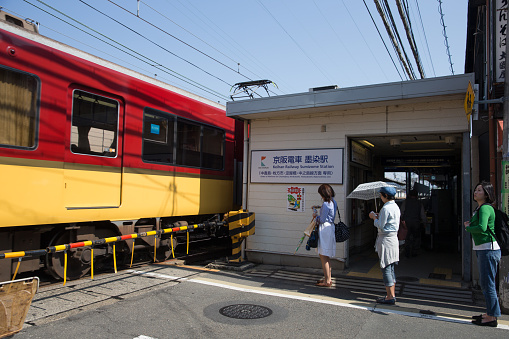 Kyoto, Japan - May 1, 2016 : People at the railroad crossing in Sumizome Station, Kyoto, Japan. Keihan Electric Railway Keihan Main Line is providing service in this station.