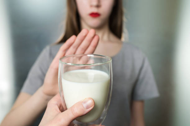 istock Lactose intolerance. Dairy Intolerant young girl refuses to drink milk 927978708