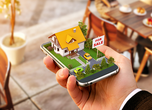 Smartphone application for online searching, buying, selling and booking real estate. Unusual 3D illustration of beautiful house on smartphone in hand