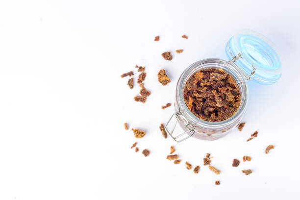 istock Glass jar with propolis granules. Bee glue. Bee products. Apitherapy. Apiculture. 927979108
