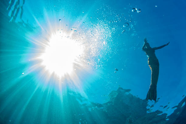 istock two Mermaid swimming underwater in the deep blue sea 927983916