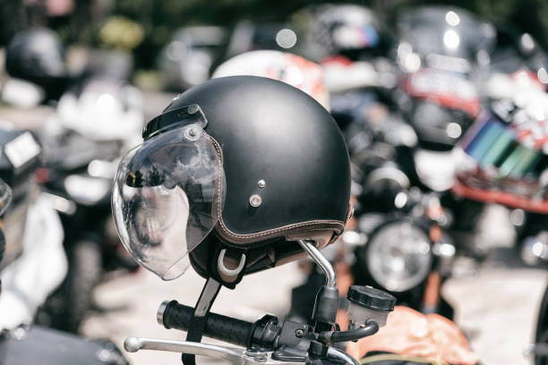 istock Vintage motorcycle helmet hanged on motorcycle in selective focus. 927983952