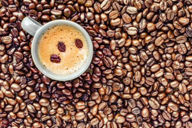 istock Coffee cup placed on a bed of coffee beans 927986554