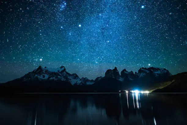 Torres del Paine National Park under starry sky reflected in the Lake of Pehoe, Chile