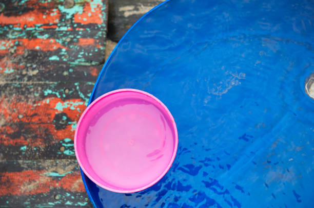 The pink water bowl put in a big water container stock photo