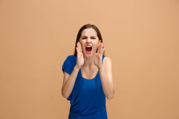 istock Isolated on pastel young casual woman shouting at studio 927995030