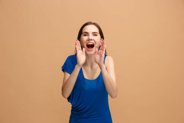 istock Isolated on pastel young casual woman shouting at studio 927995292