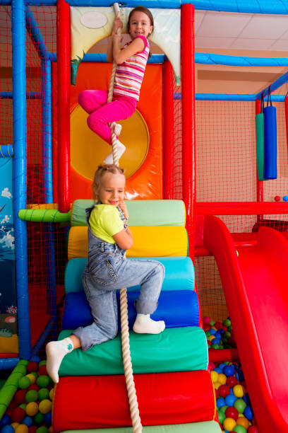 istock Kids playing in a pool of balls 927995466
