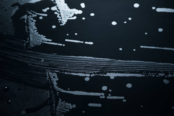 istock wet traces of water on a black matte surface 927998284