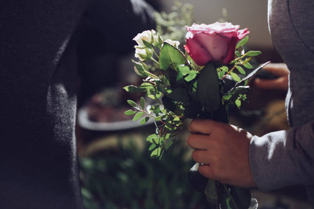istock Modern florist working with flowers in workshop - with detail on hands 927998436