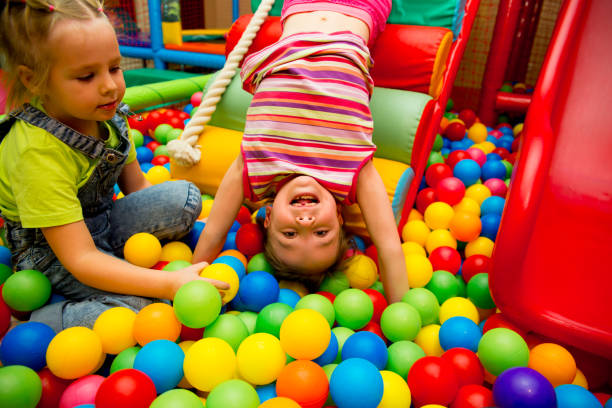 istock Kids playing in a pool of balls 927998790