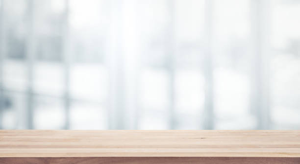 istock Wood table top on white abstract background form office building. 927999184