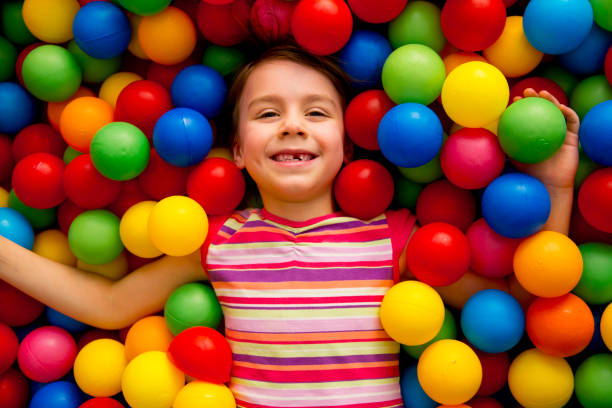 Group of kids plaing in a pool of balls