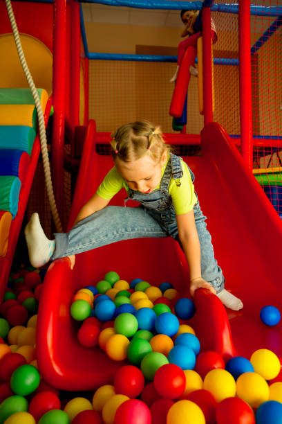 istock Kids playing in a pool of balls 928002226
