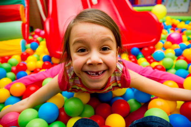 istock Kids playing in a pool of balls 928002288